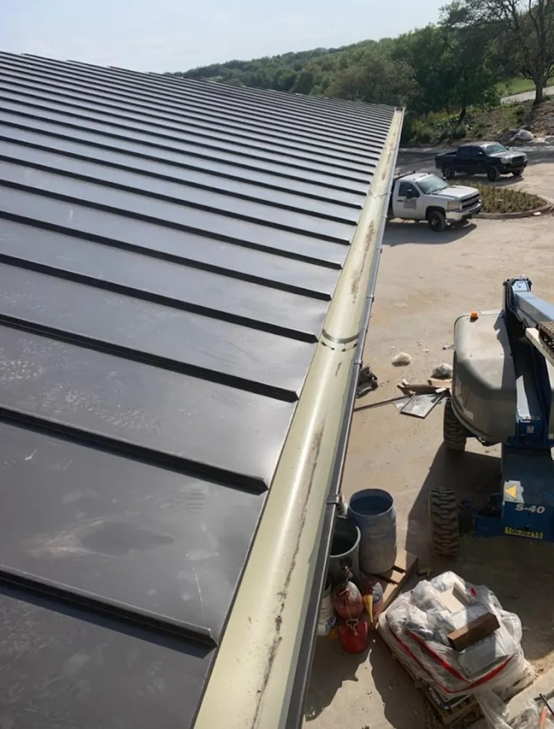 Standing seam panel and gutter detail on a metal roofing jobsite in Smithfield
